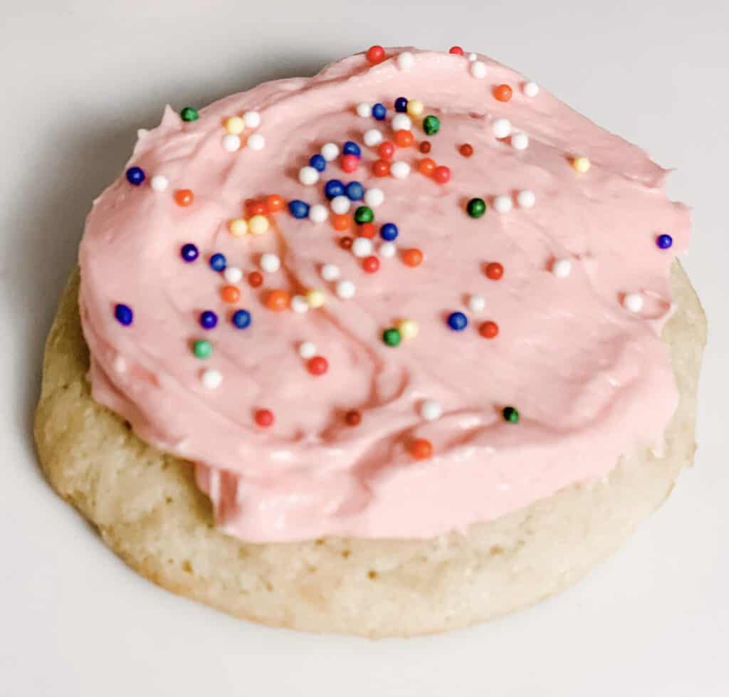 Pink Icing on a Gluten Free Sugar Cookie with Sprinkles