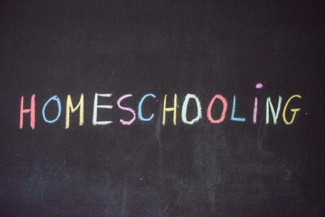 Homeschooling written on a chalkboard with different color chalk