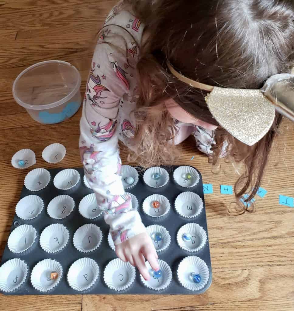 girl sorting marbles for school