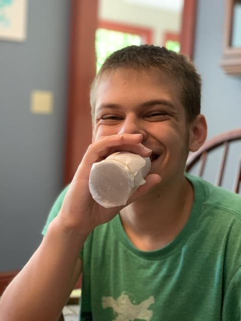 Boy playing with homemade Kazoo - Fun Experiments with sound