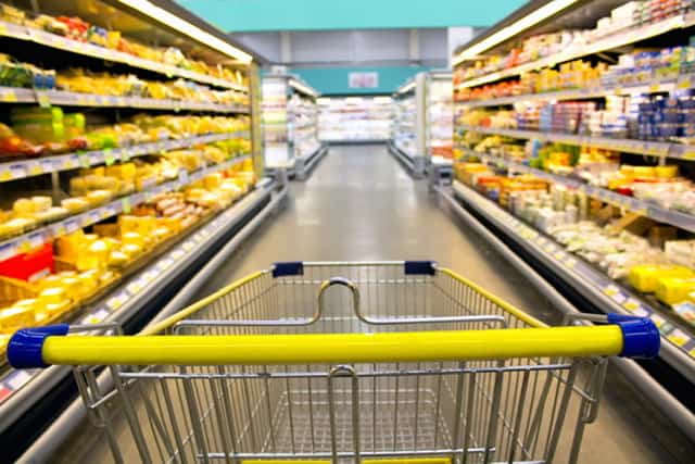 Grocery cart int he center of the aisle at the grocery store