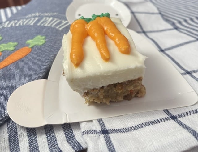 piece of carrot cake decorated with carrots on a rabbit plate