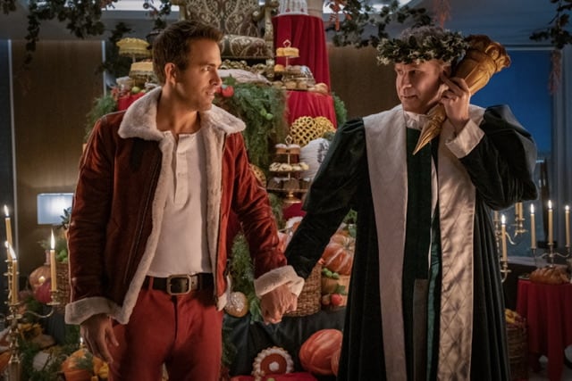 Will Ferrell as Ghost of Christmas Present and Ryan Reynolds as Clint Briggs in Spirited