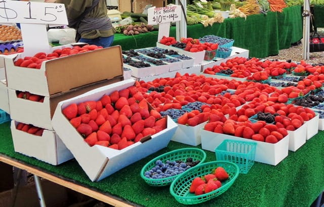 Farmers market with strwaberries and blueberries