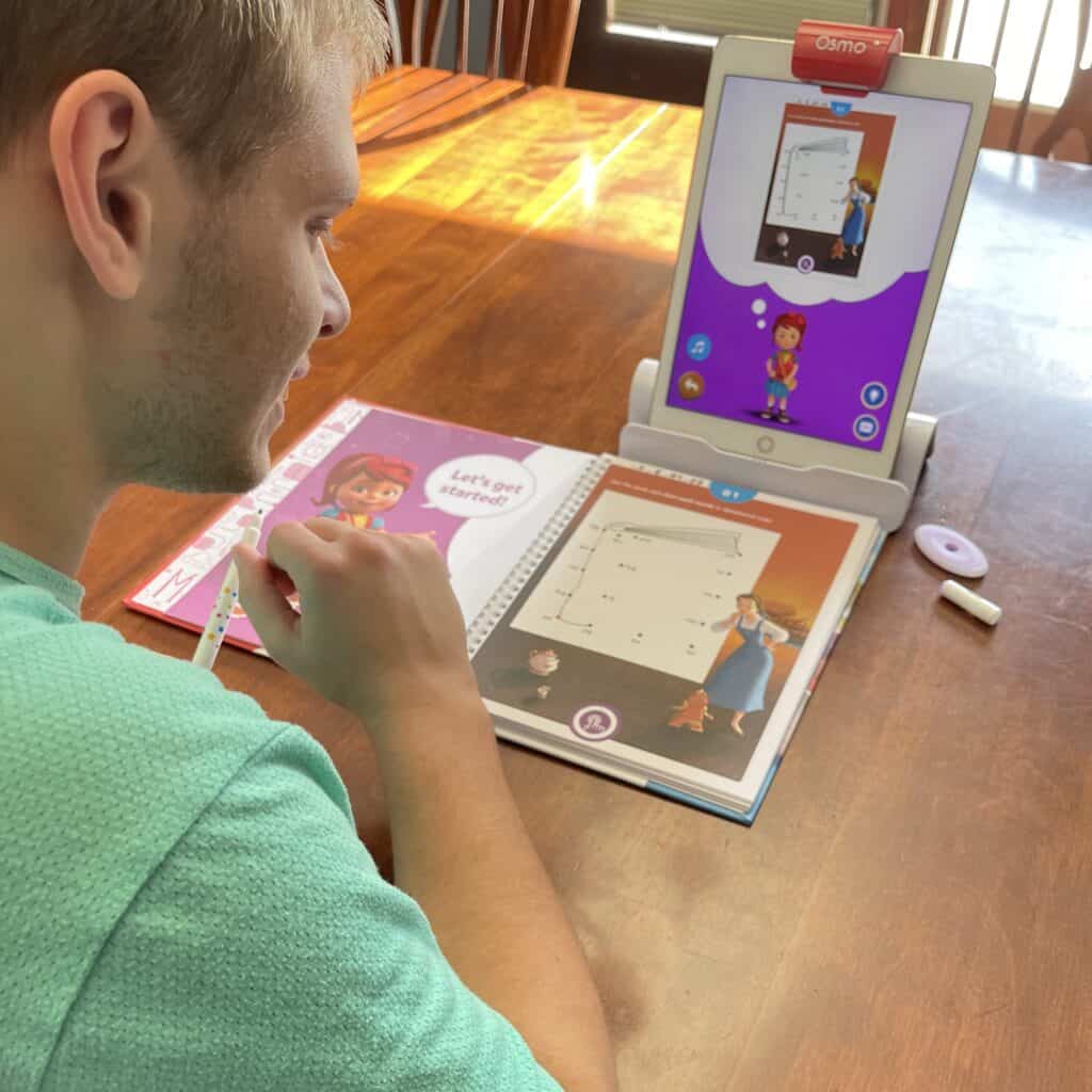 Boy working on reading with BYJU's Learning featuring Disney