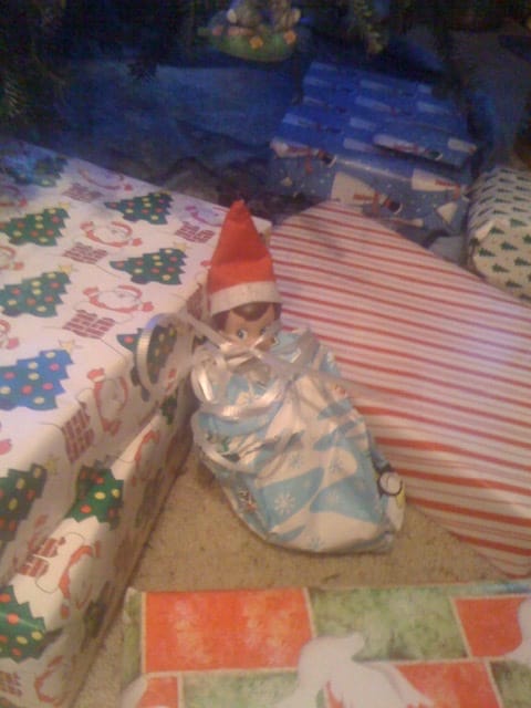 Elf on the shelf hiding with the presents