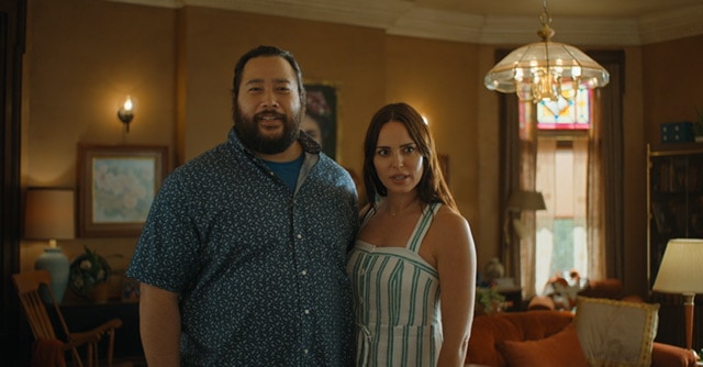 Two parents standing in living room