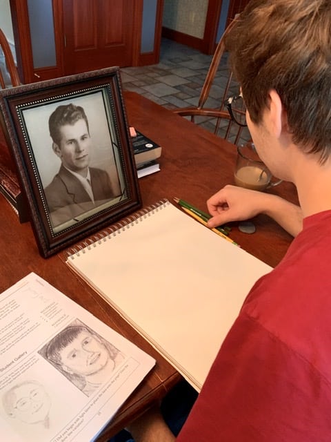boy with photo of grandfather for art class
