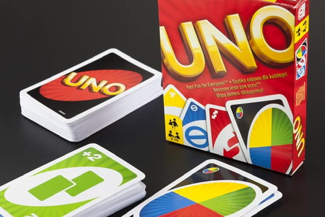 Uno card game box with cards on a table