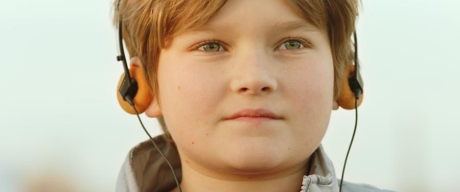 Young Bart Millard listening to his walkman in the movie I can Only Imagine