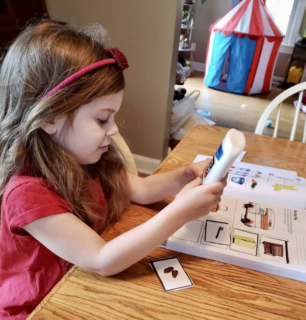 Girl gluing schoolwork