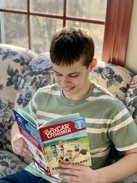 Boy reading Early Readers The Boxcar Children Surprise Island