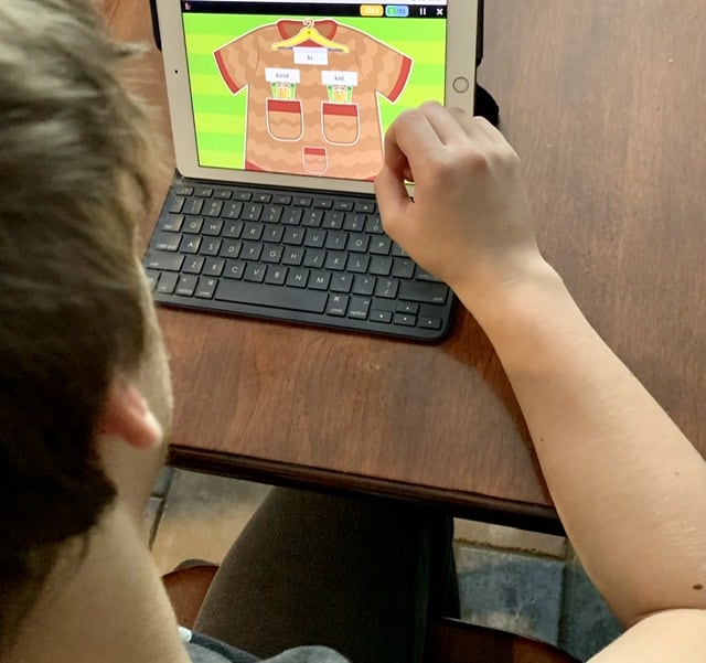 Boy learning to read using an ipad