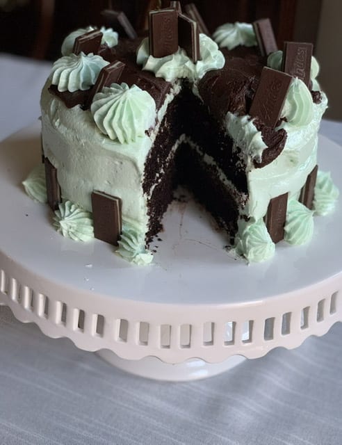 mint andes candy gluten free chocolate cake on a white cakestand