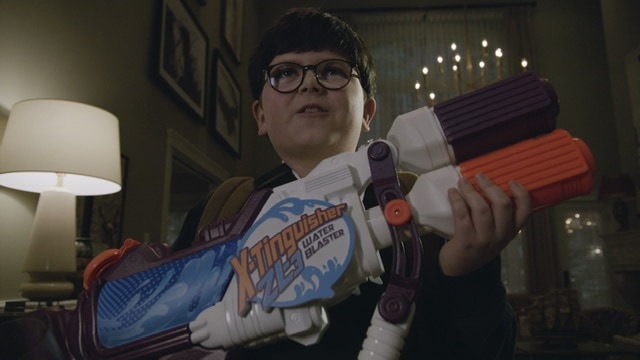 Max Mercer in Home Sweet Home Alone. Boy holding a Water blaster gun