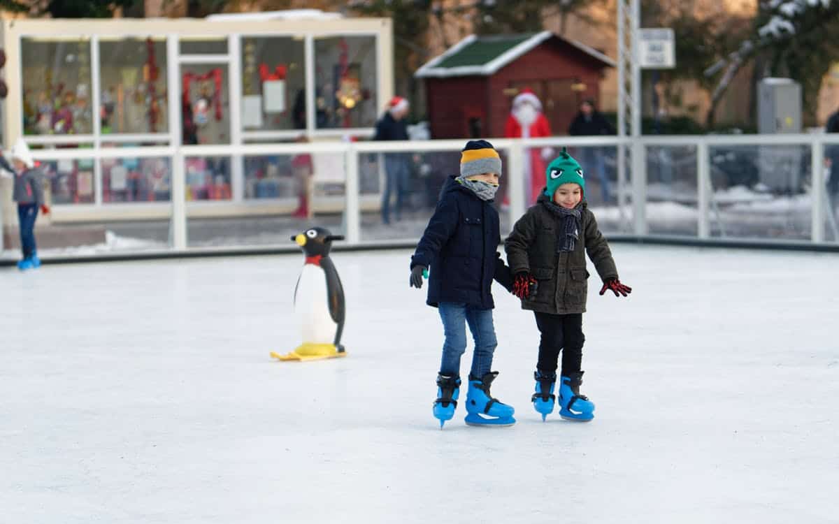Children ice skating outside