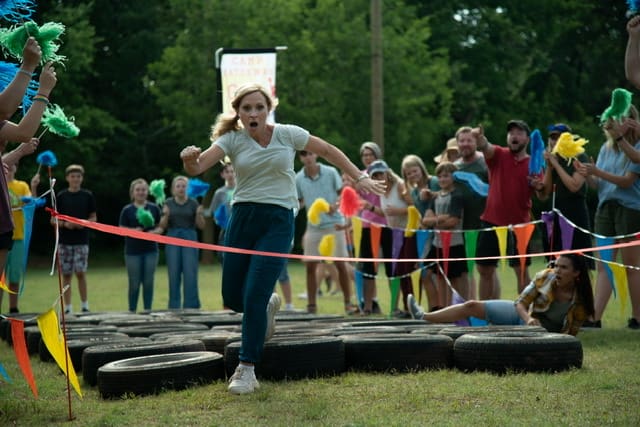 woman running through tires obstacle course