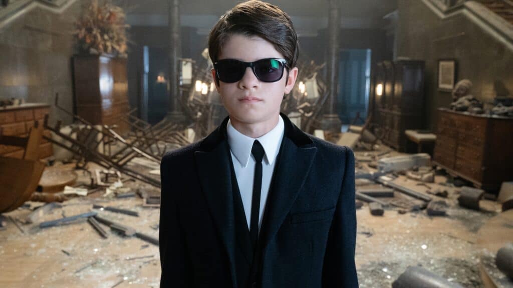Artemis Fowl standing in a destroyed house
