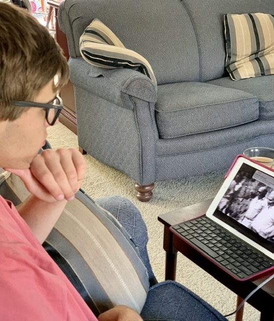 Young man watching iPad Bible Unearthed