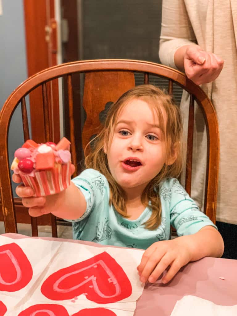 Girl holding Valentine Cupcake