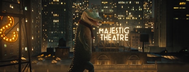 Lyle the Crocodile in front of a Majestic Theatre light up sign in New York