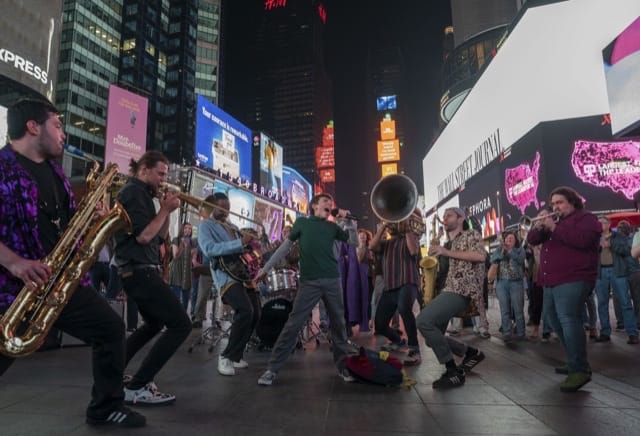 Nate in Times square sining with a band