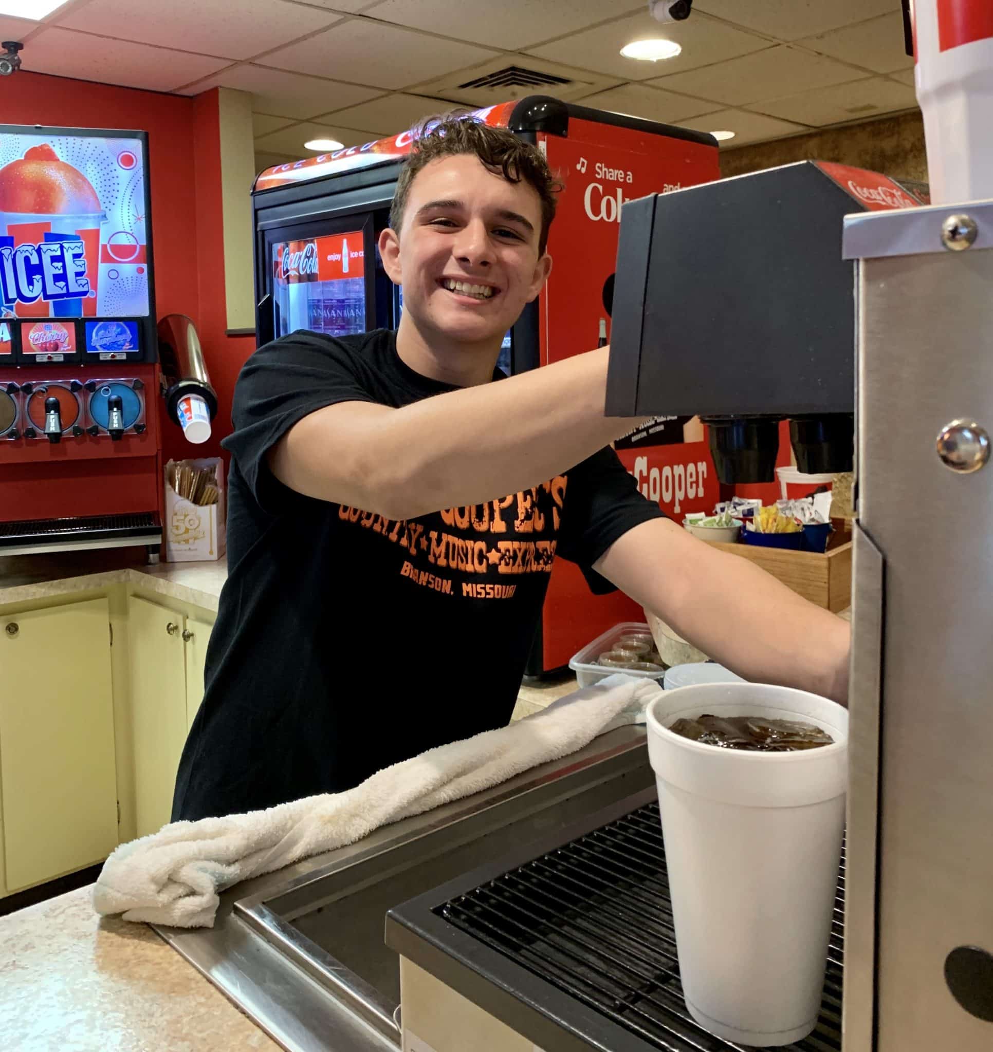 Colt Cooper serving drinks and popcorn at Clay Cooper Country Express