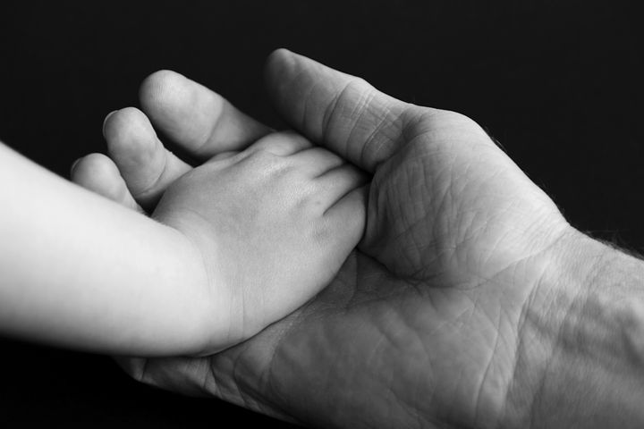 Dad holding child's hand