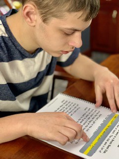 Child Learning to Read using Pride Reading Program
