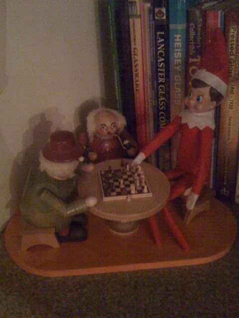 Elf on the Shelf playing chess with smokers