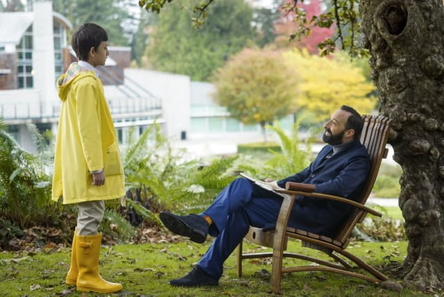 Mr. Curtain (Tony Hale) and Reynie in the garden