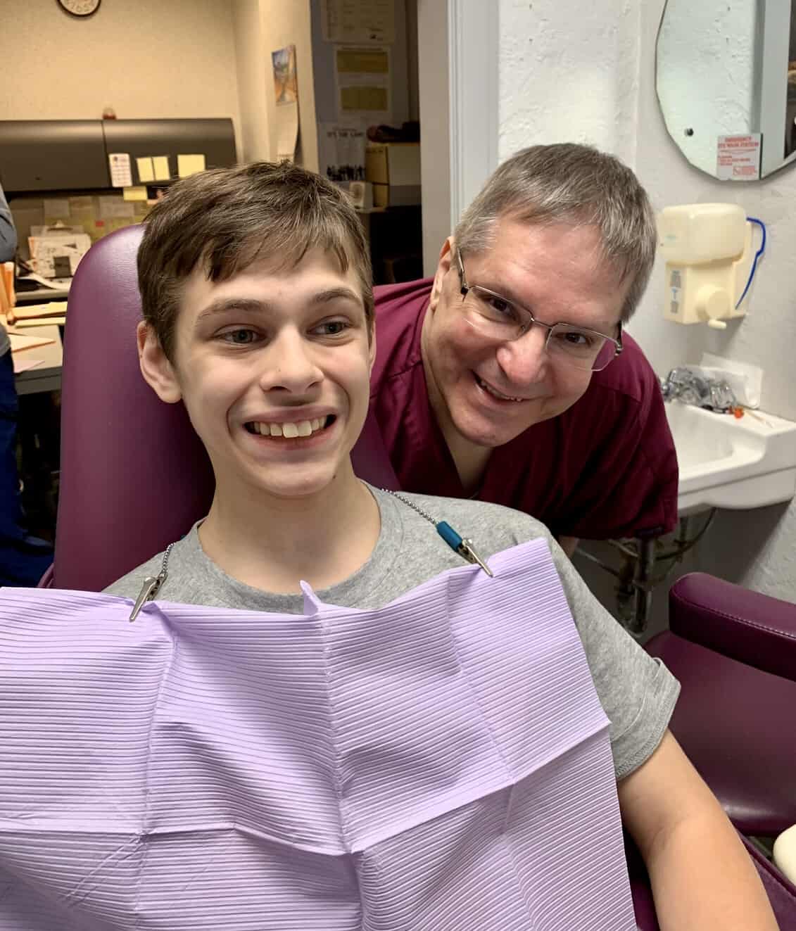 Boy in dental chair with dentist