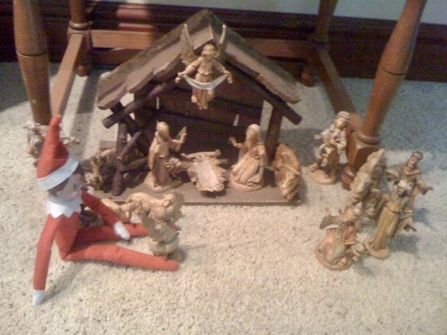 elf on the shelf waiting for Jesus by the manger