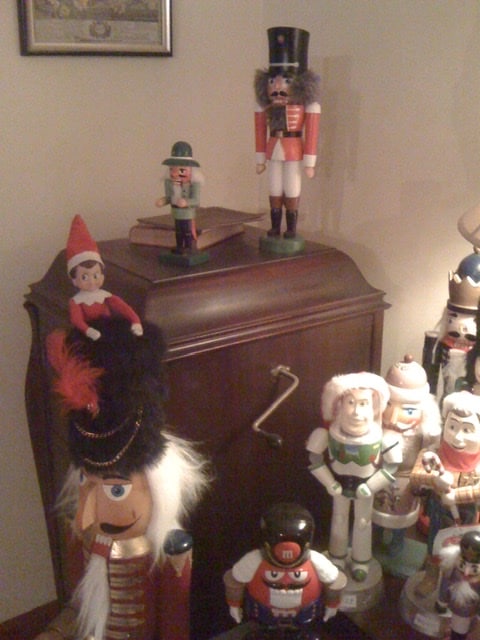 Elf on the Shelf hanging out with nutcrackers