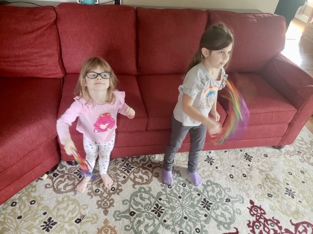 Two girls playing with scarves watching a Musik at Home Homeschool Review