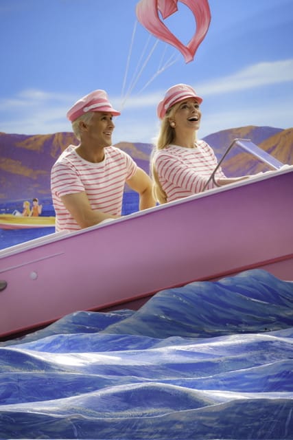 Ryan Gosling as Ken and Margot Robbie as Barbie in a pink boat.