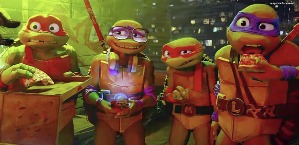 Donatello, Raphael, Michelangelo, and Leonardo from the Teenage Mutant Ninja Turtles: Mutant Mayhem. This photo depicts the four turtles eating pizza.