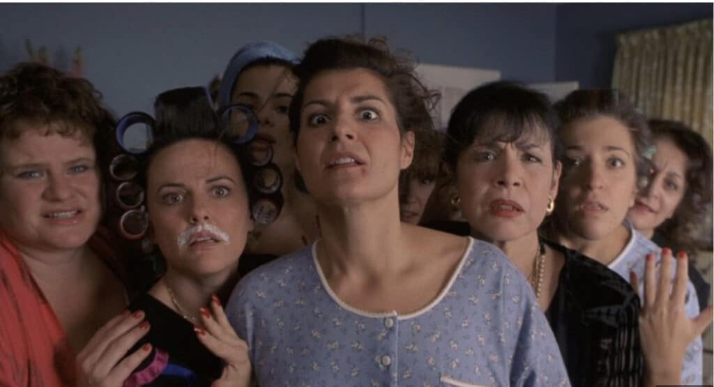 Women from My Big Fat Greek Wedding getting ready on the wedding day. Toula has a zit below her lip.