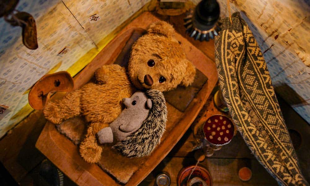 A Teddy Bear (voiced by Zachary Levi) cuddles with a stuffed hedgehog.