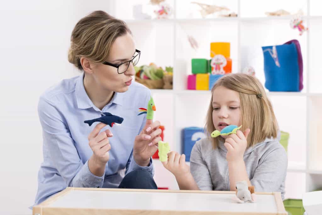 Sensory Therapy play - photo shoes young girl and woman playing with finger puppets