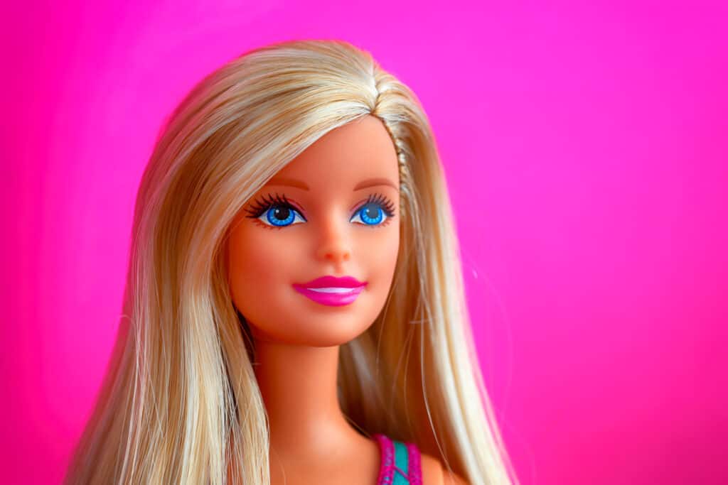 Blonde Barbie doll on a hot pink background