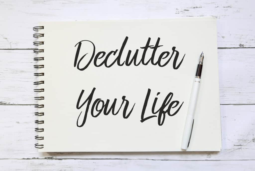 declutter your life written on a pad of paer