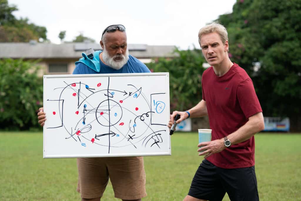 Next Goal Wins. Coach Thomas Rongen writes plays on a white board.