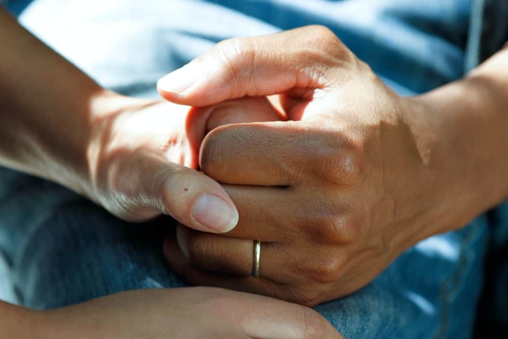 woman holding man's hand